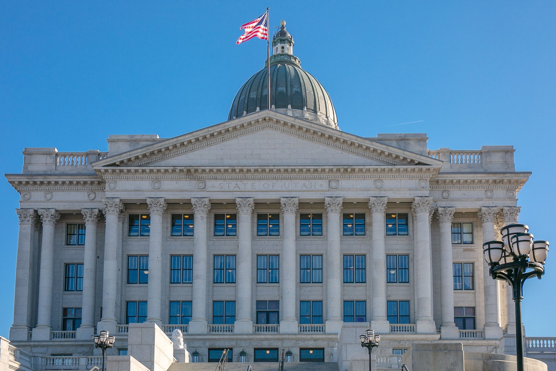 A US state capitol building with the American flag